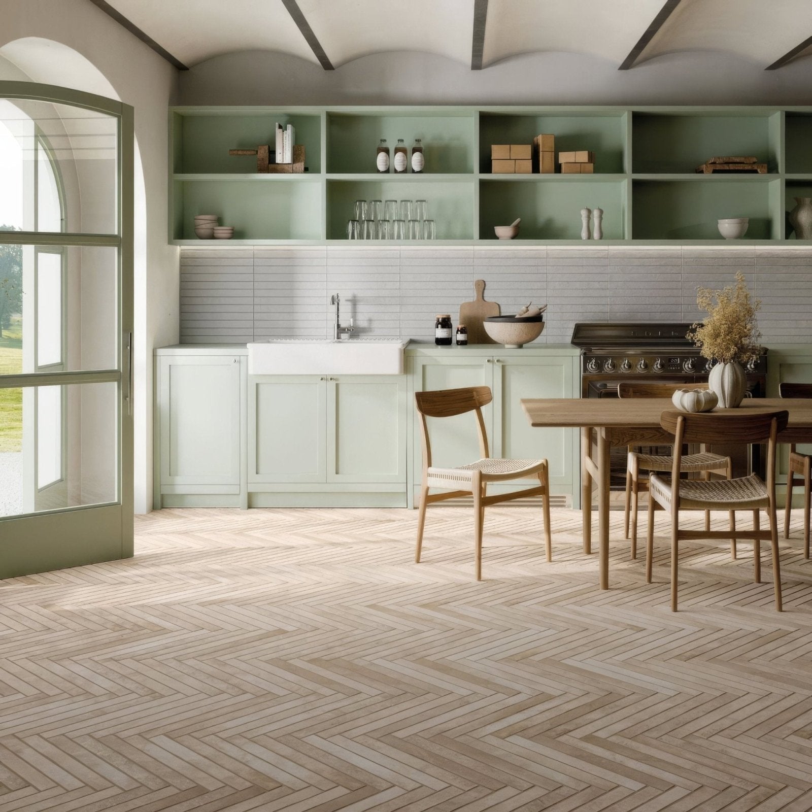 Light green painted kitchen cabinets with white subway tile backsplash and wooden dining set on ramsbury sand terracotta effect tiles