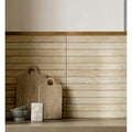 Two rustic wooden cutting boards with natural grain and round handles on ramsbury sand terracotta effect tiles