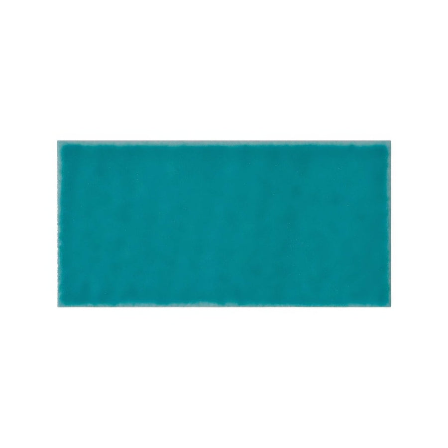 A solid teal rectangular Ravello Frezza tile with a smooth glossy finish ideal for wall and floor surfaces