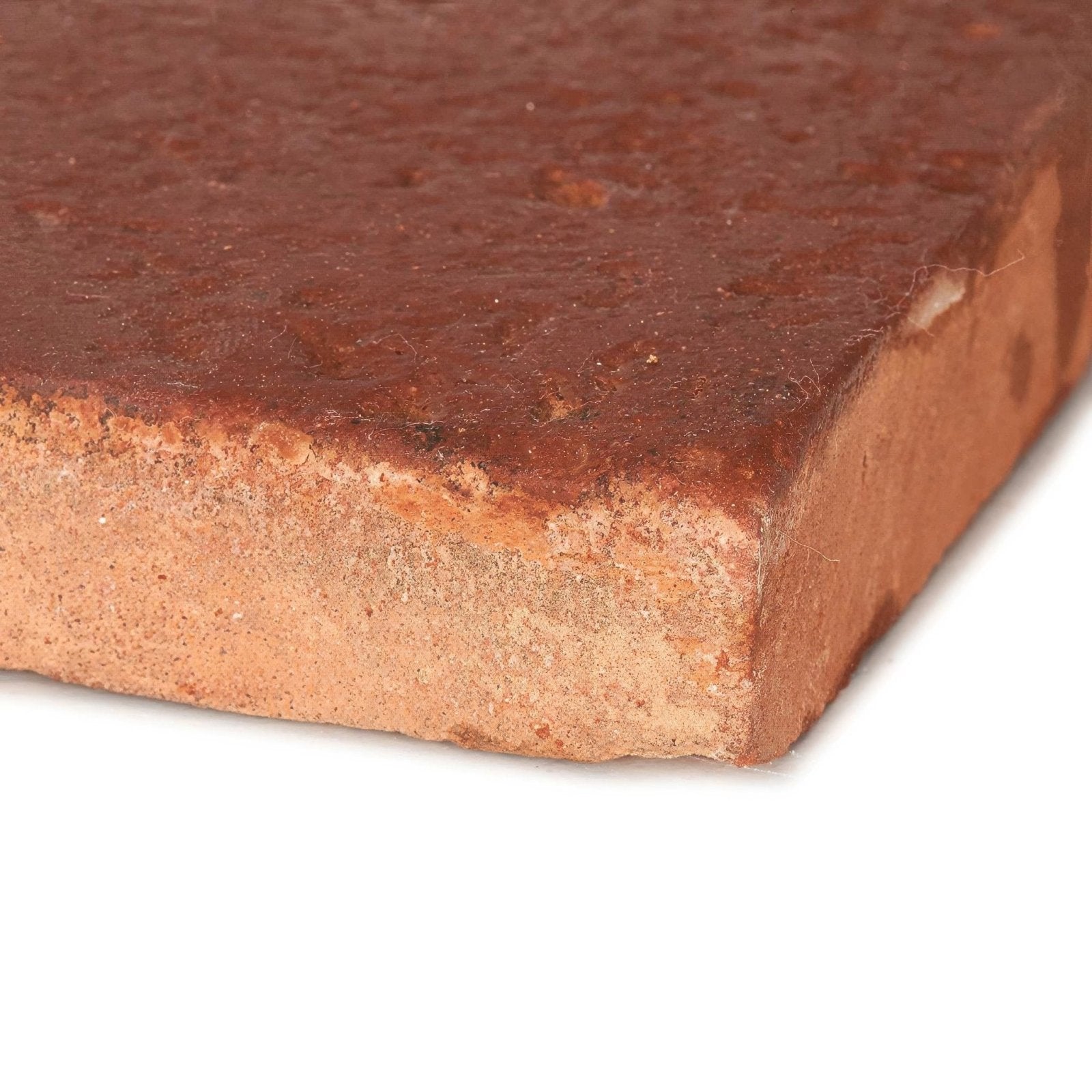Reclaimed terracotta square tile 15x15 made of weathered reddish brown clay brick with rough textured surface and mortar residue