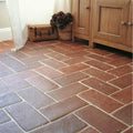Reclaimed terracotta square tile 15x15 with reddish-brown color laid in a herringbone pattern for flooring use