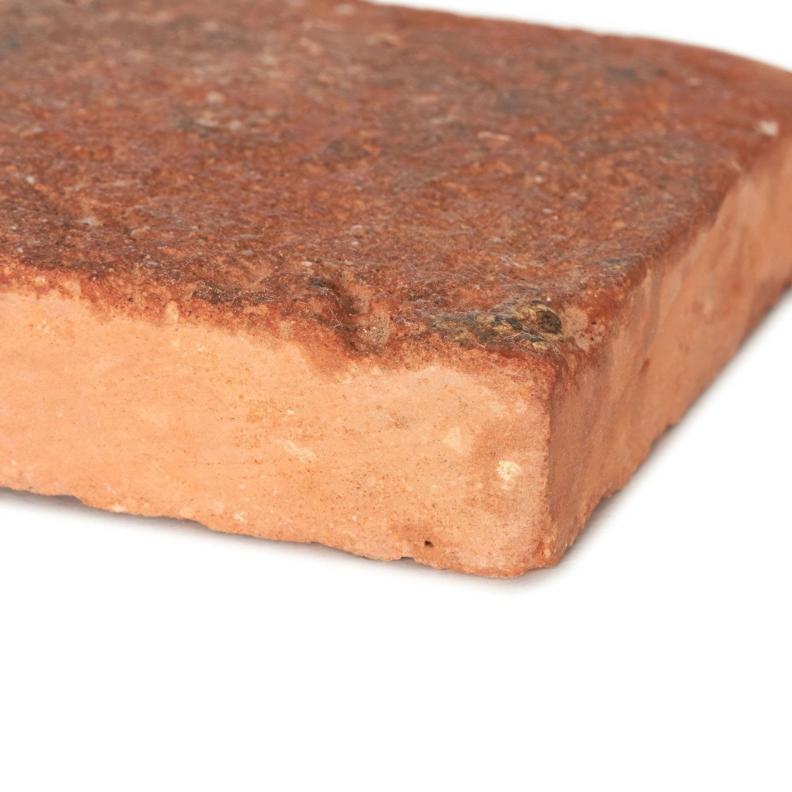 Reclaimed terracotta rectangle tile 7.5x30 showing a rustic reddish-brown clay brick with textured weathered surface and mortar residue