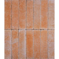 Terracotta colored reform composite stone tumbled cotto rectangular tiles with a textured rustic surface