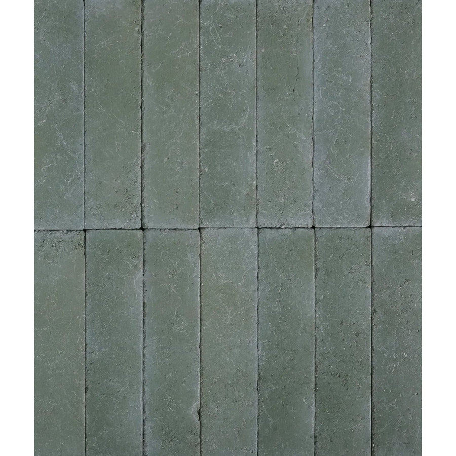Gray rectangular reform composite stone pavers with textured slightly weathered surface in tumbled leaf green color