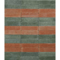 Rectangular reform composite stone tiles in tumbled leaf green and muted terracotta arranged in a striped pattern