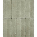 Gray stone tiles with textured natural finish arranged in vertical rows reform composite stone tumbled mint