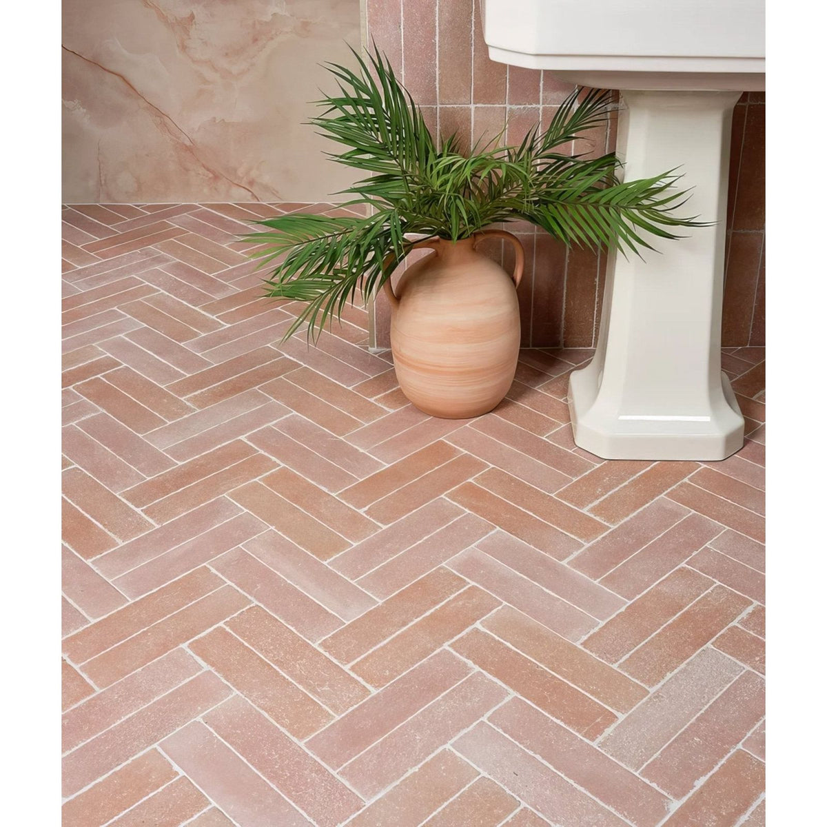 Reform composite stone tumbled salmon pink terracotta herringbone floor tiles with a matte finish