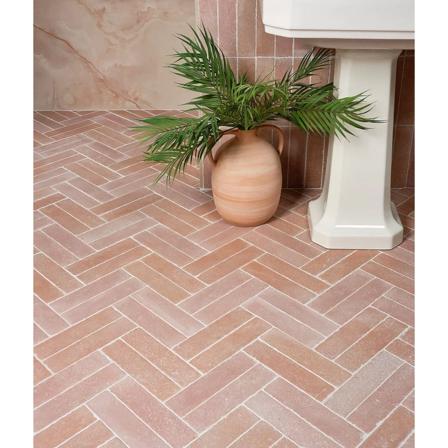 Reform composite stone tumbled salmon pink terracotta herringbone floor tiles with a matte finish