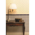 Brass arm lamp with white pleated shade featuring regency stripe royal blue on county white textile design