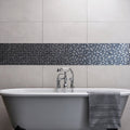 Rena Earth and Fire Mixed Mosaics blue and grey glass mosaic with a white clawfoot bathtub