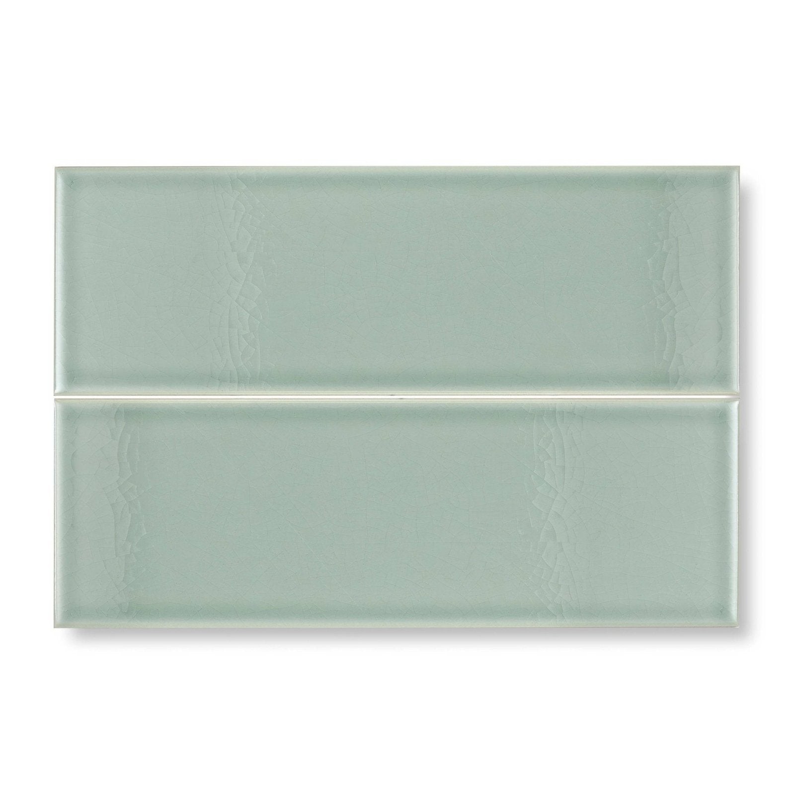 Two rectangular glazed glass tiles in soft sage green with subtle textured patterns retro metro lime house 10 x 30