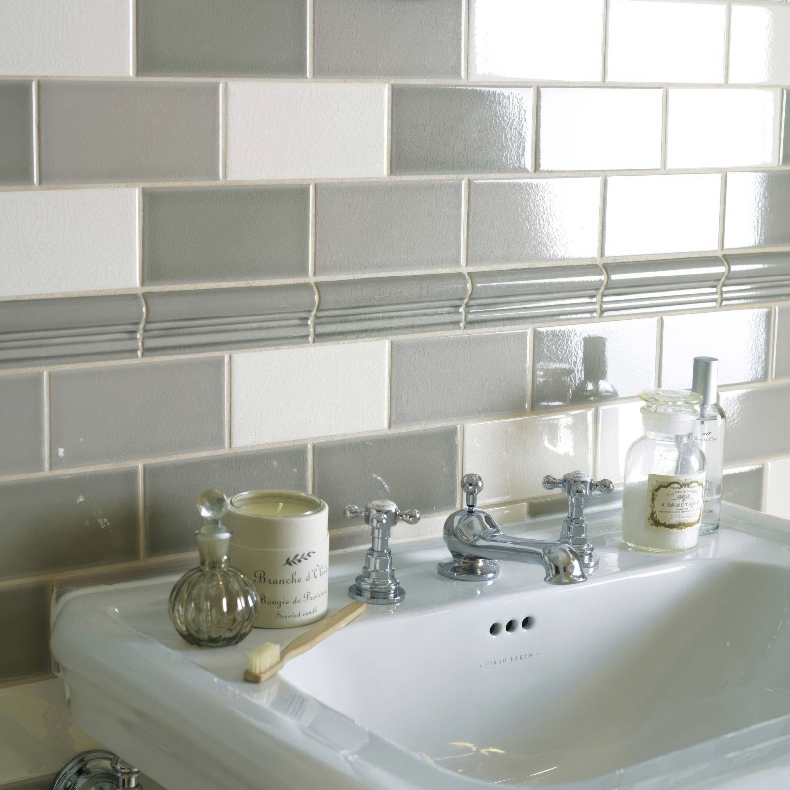 Chrome finished vintage style bathroom faucet with ornate cross handles and central spout on retro metro south kensington glazed tile