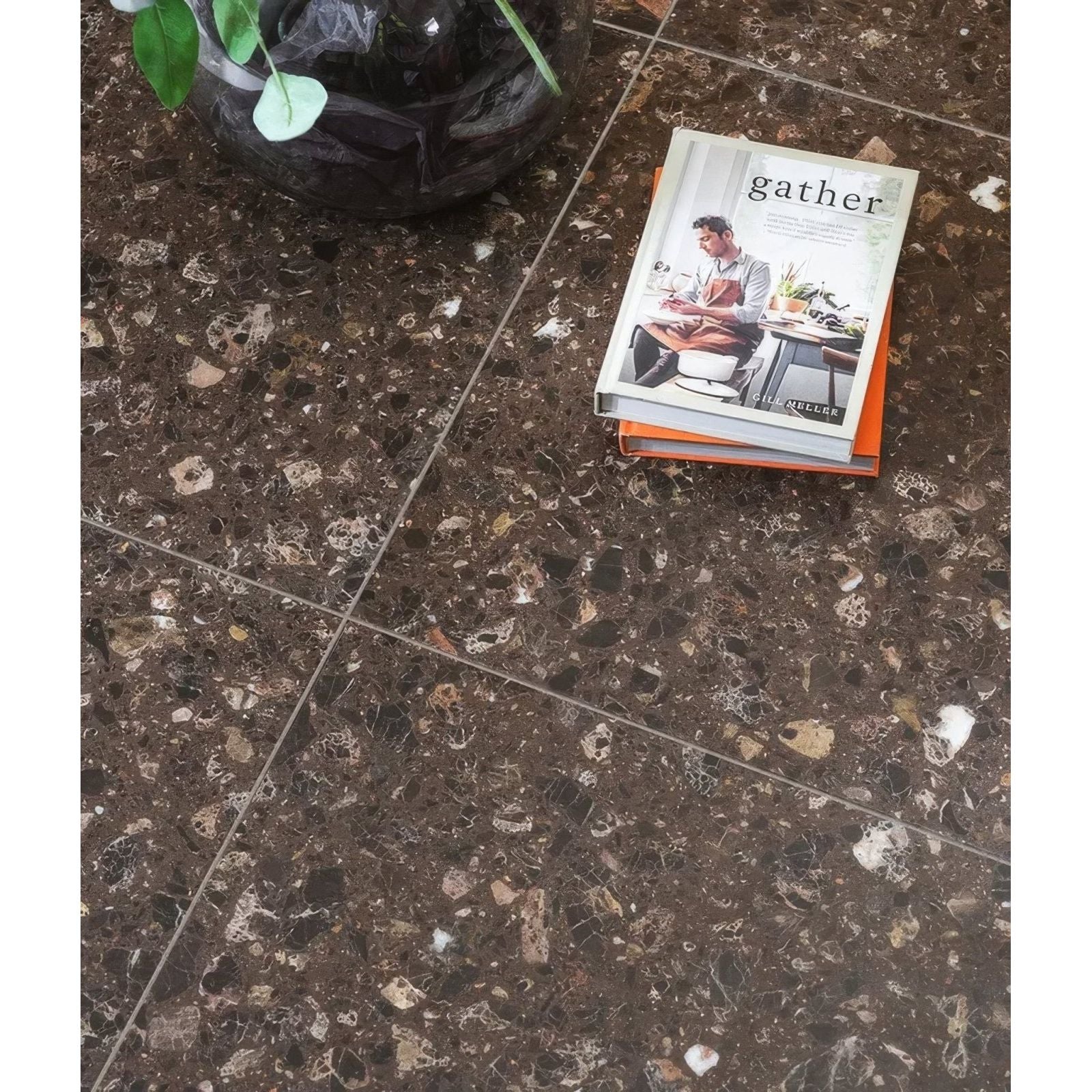 Rialto Terrazzo Ca'Doro Honed dark brown terrazzo tiles with a cookbook
