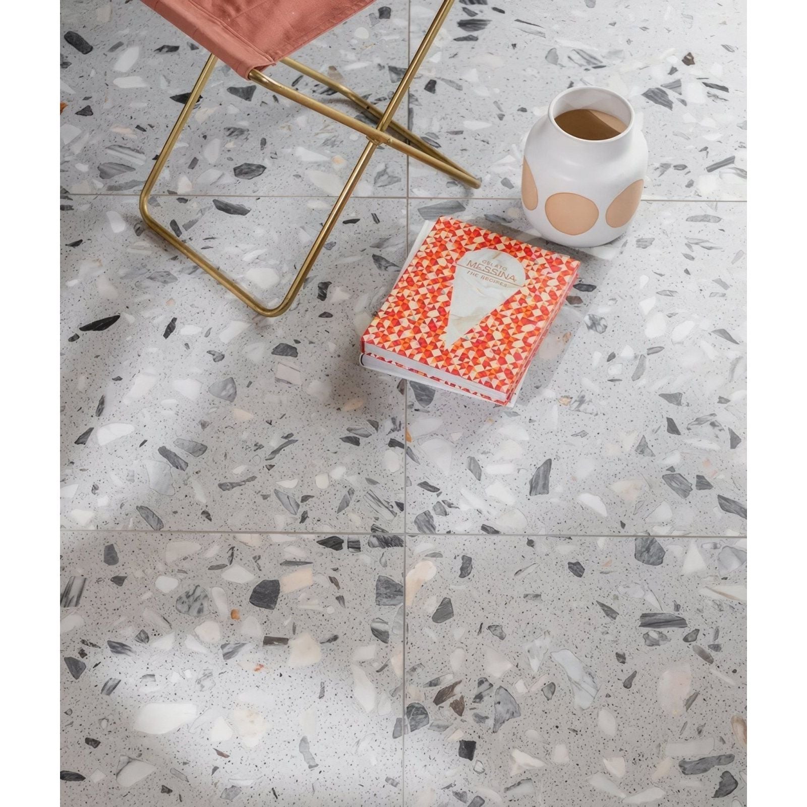 Rialto Terrazzo Castello Honed grey terrazzo tiles with a white ceramic vase