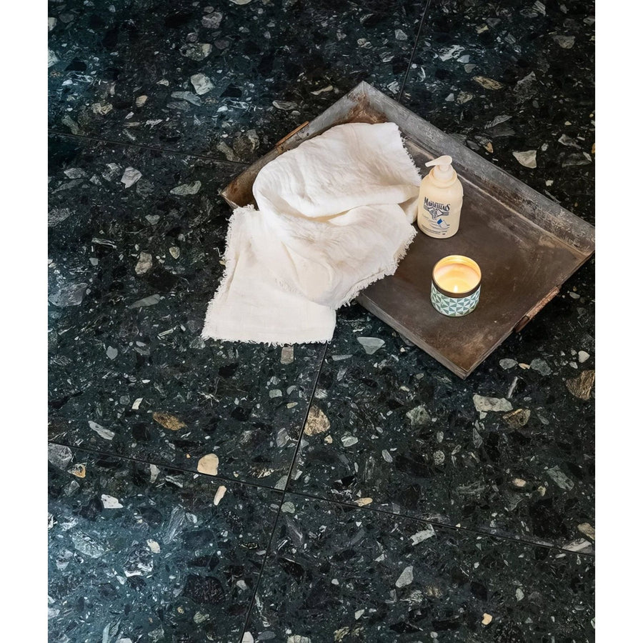 Rialto Terrazzo Foscari Honed dark green terrazzo tiles with a metal tray and soap bottle