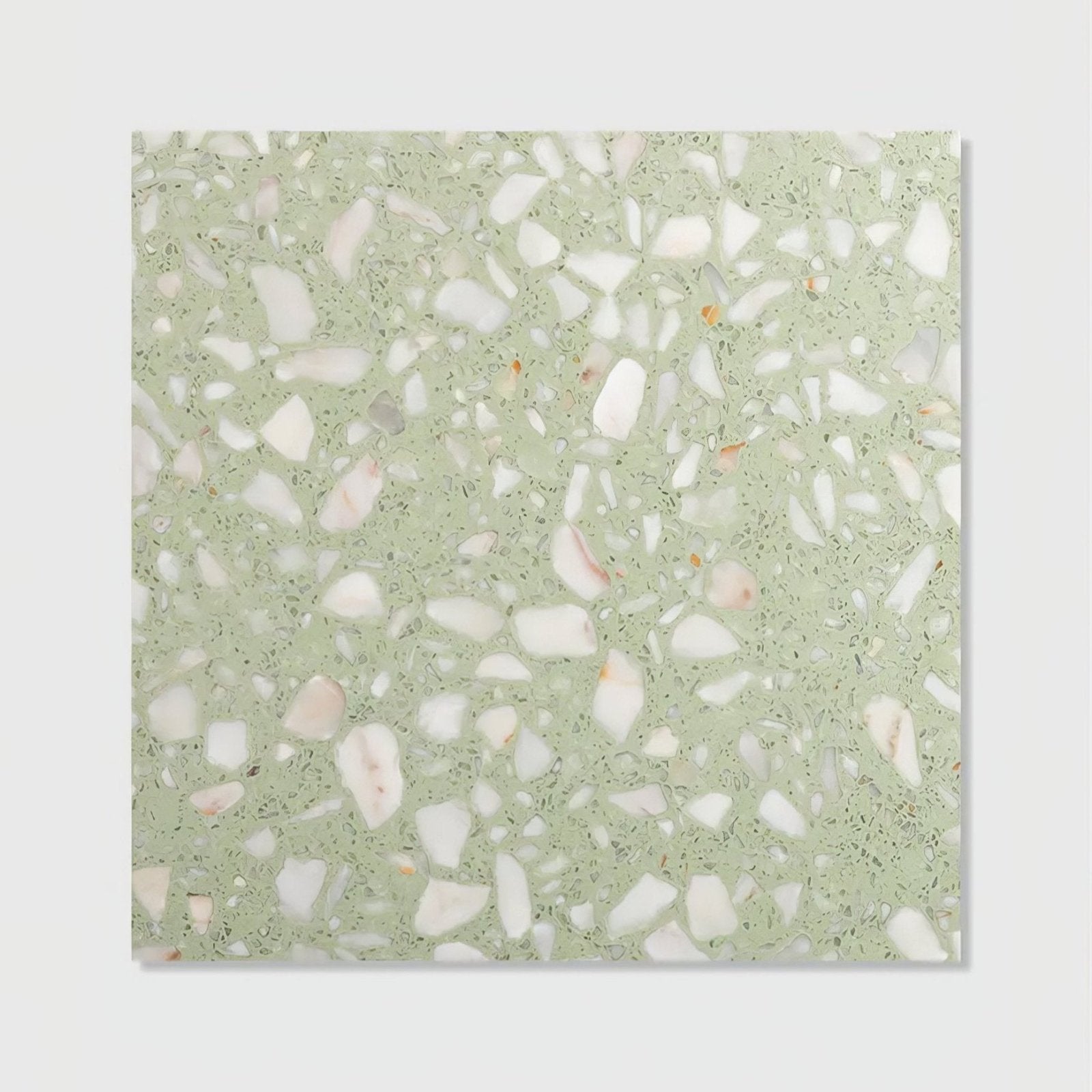 A square rialto terrazzo laguna honed tile with a light green base and white pinkish orange aggregate pieces