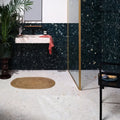 Dark green rialto terrazzo veneta honed tiles with speckled texture covering bathroom walls