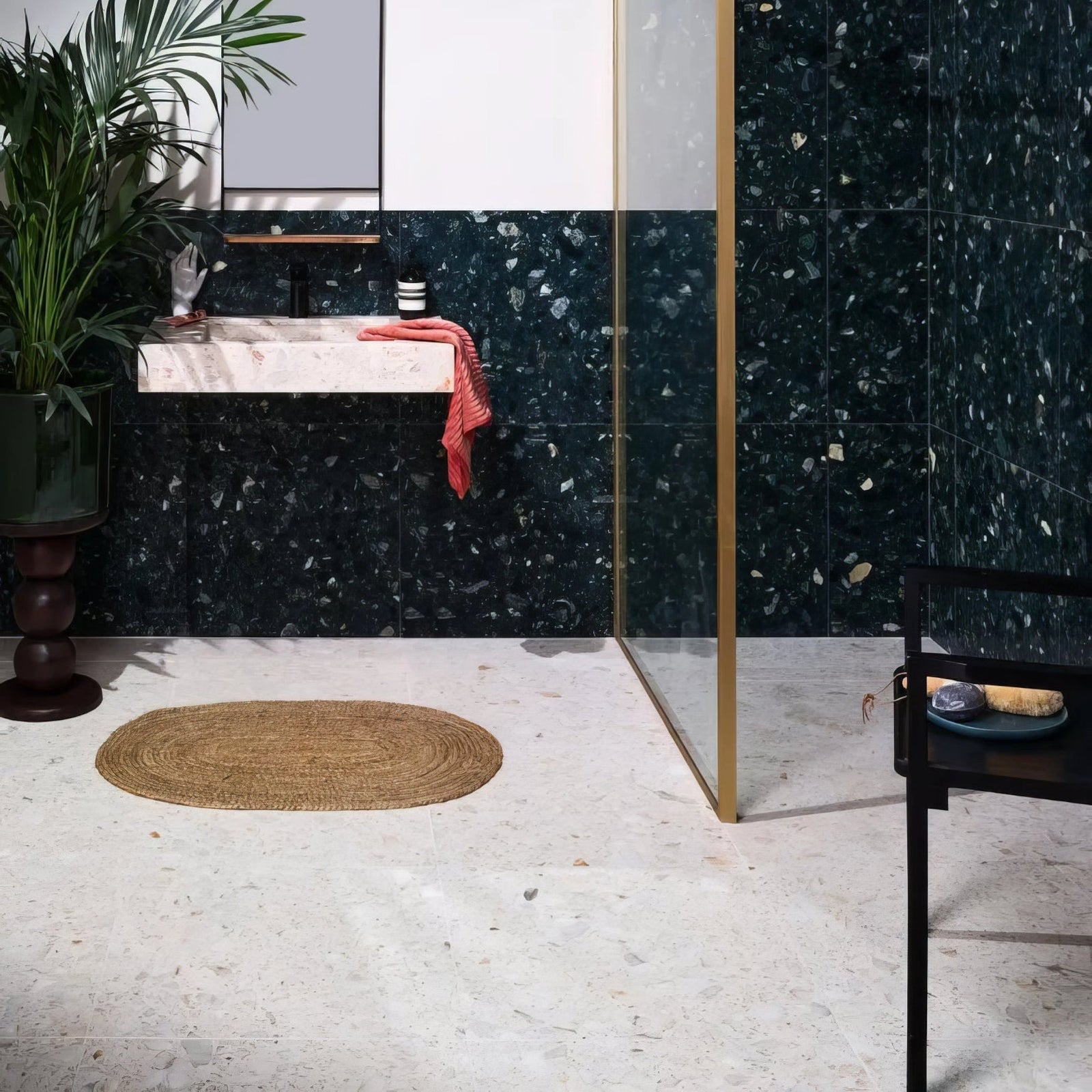 Dark green rialto terrazzo veneta honed tiles with speckled texture covering bathroom walls