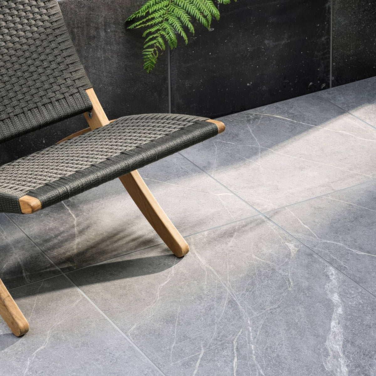 Modern woven black chair with light wood legs featured in product Rimini Grey 60 x 120cm design