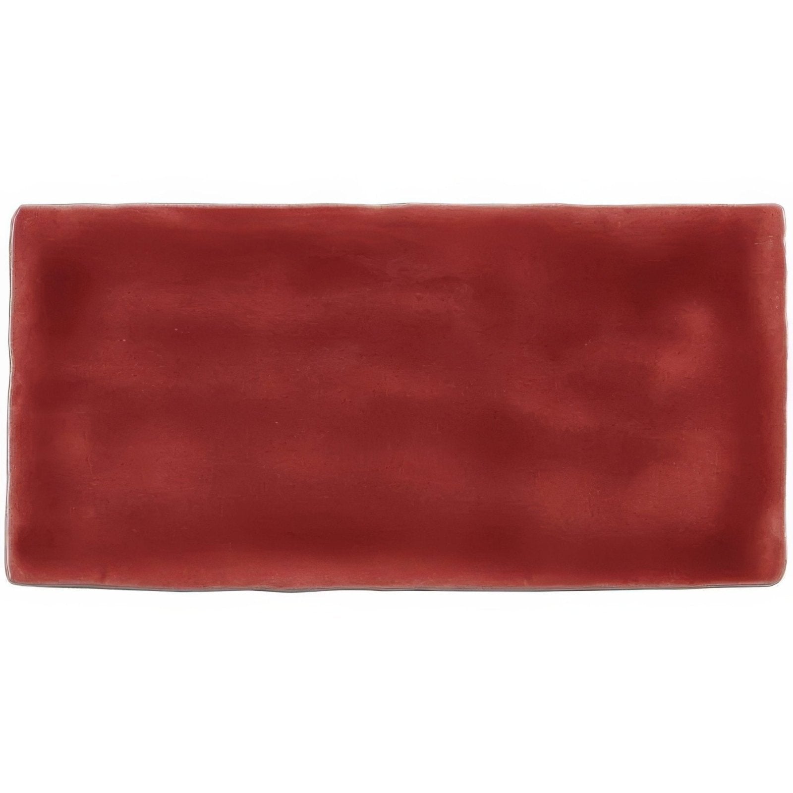 A rectangular terracotta-colored rioja brick tile with a matte finish and subtle textured ceramic surface