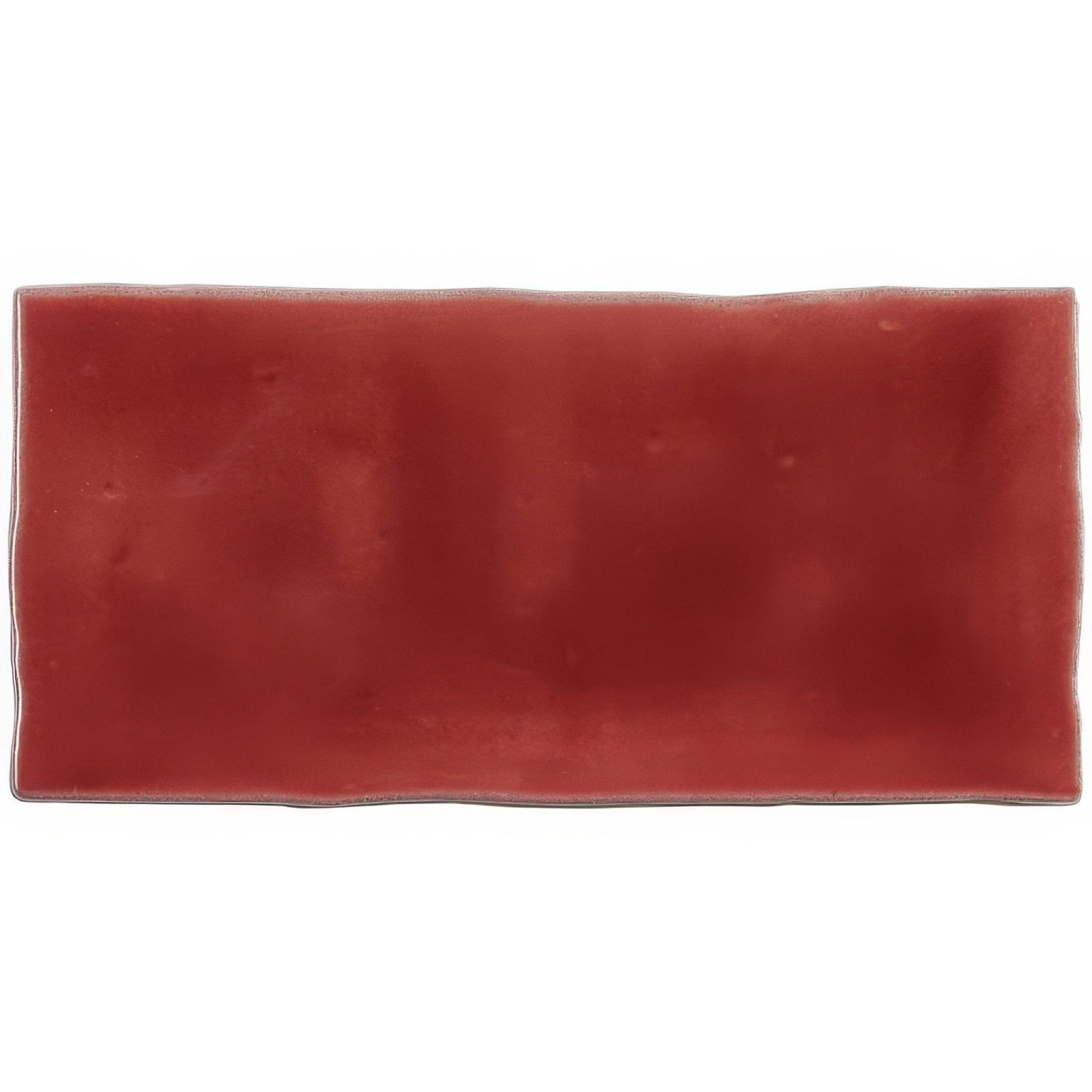 A rectangular matte finished terracotta ceramic rioja half tile wall tile with slightly irregular edges