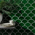 Deep emerald green scalloped ceramic tiles with white grout lines forming a modern Riverlands Scales backsplash