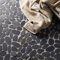 Dark gray smooth-stone mosaic tiles in a pebble pattern from riverstone black flat cut pebble mosaic collection