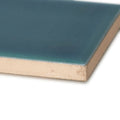 A square ceramic tile retro metro green park 5 x 20cm with a glossy teal glaze and beige unglazed underside