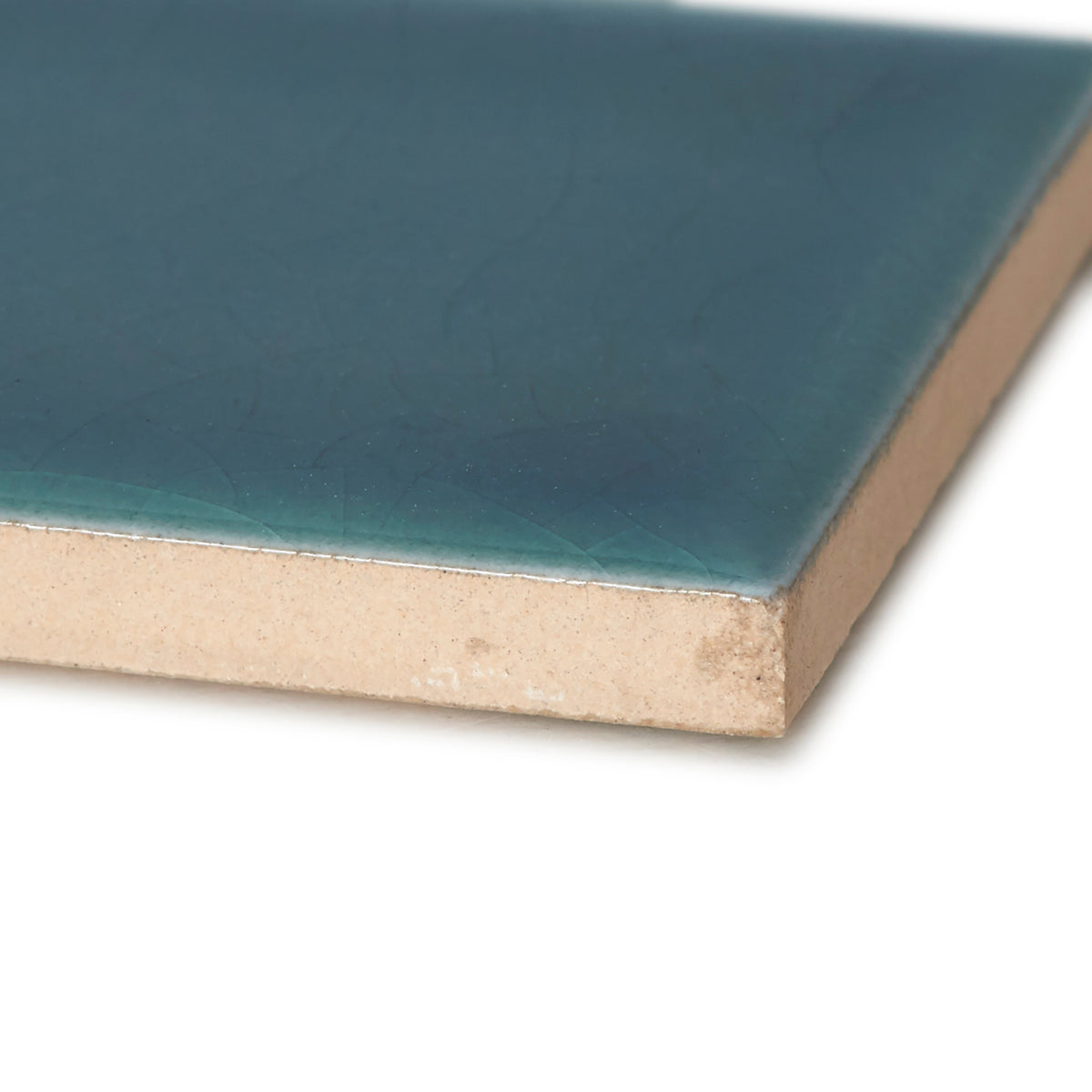 A square ceramic tile retro metro green park 5 x 20cm with a glossy teal glaze and beige unglazed underside