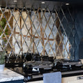 Black ceramic cooktop with glossy finish and diamond-patterned mirrored backsplash from rococo mirror diamond glass mercury