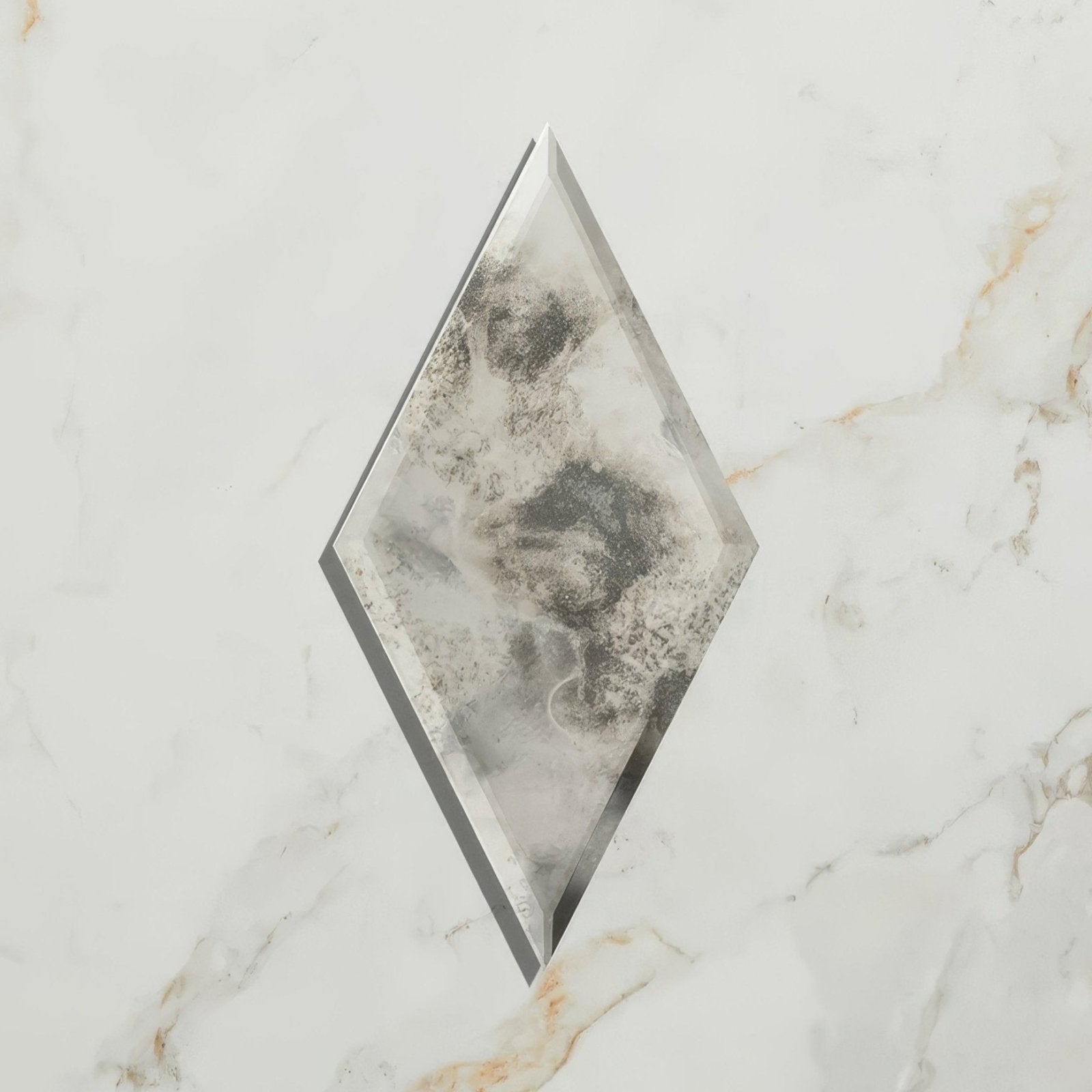 A diamond-shaped rococo mirror diamond glass mercury tile with cloudy grayish-white marbled pattern and beveled edges
