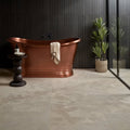A freestanding roma limestone velvet finish copper bathtub with smooth polished finish and elegant curves