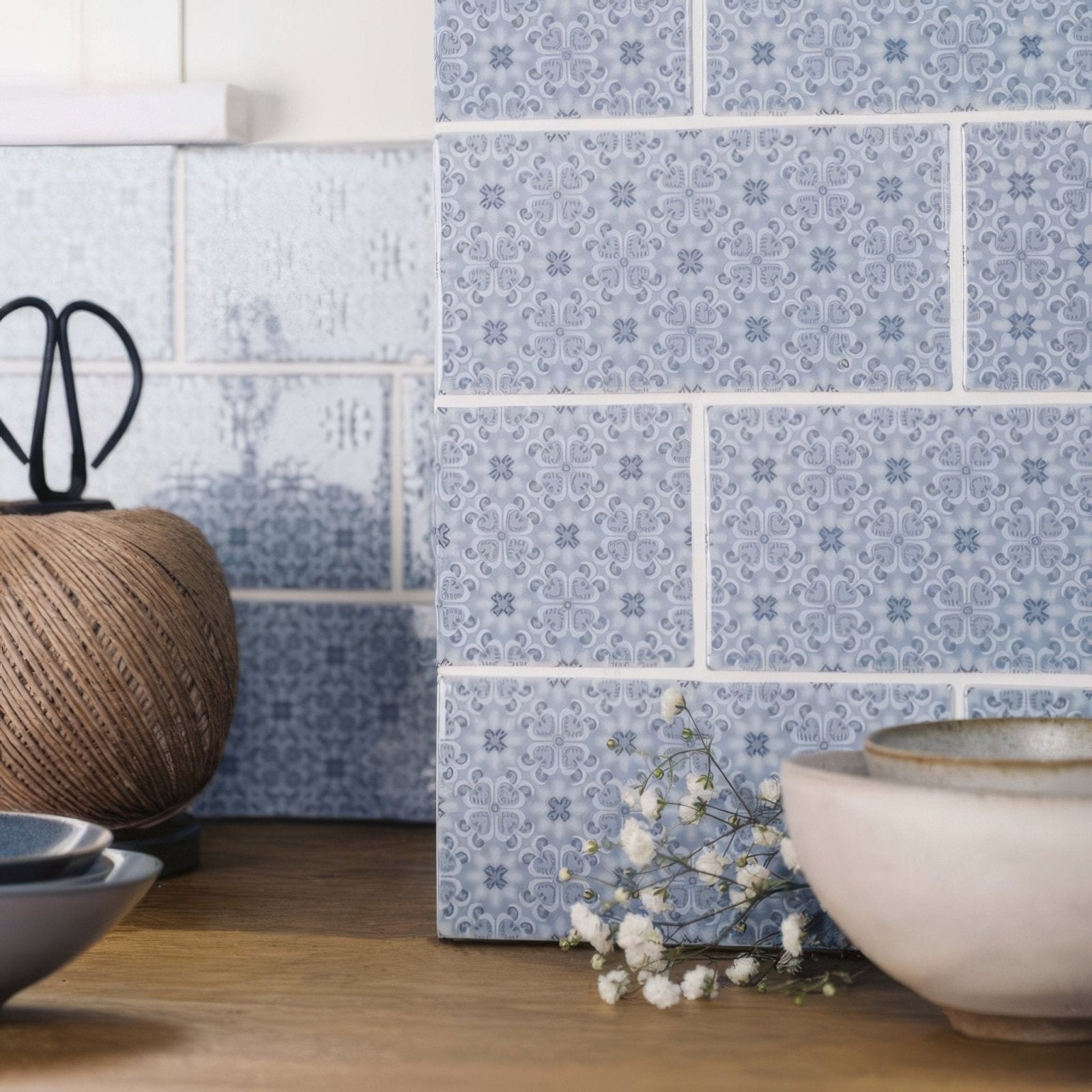 Light blue ceramic tiles rosemoor on snape with subtle repeating floral pattern for decorative wall use