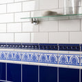 Blue and white ceramic tile border with ornate leaf patterns from royal blue dentil moulding collection