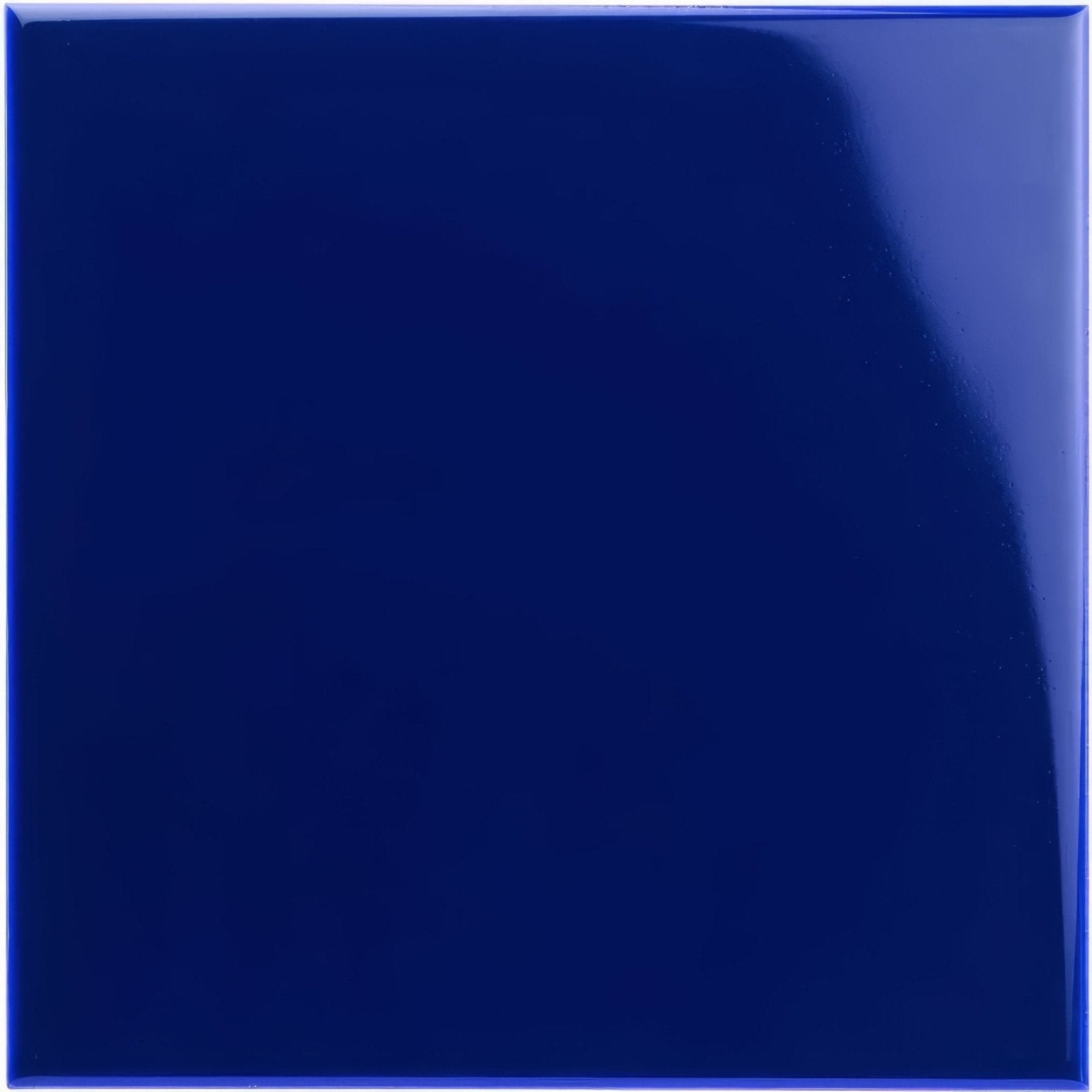 A glossy royal blue ceramic field tile with a smooth reflective surface for interior and exterior use