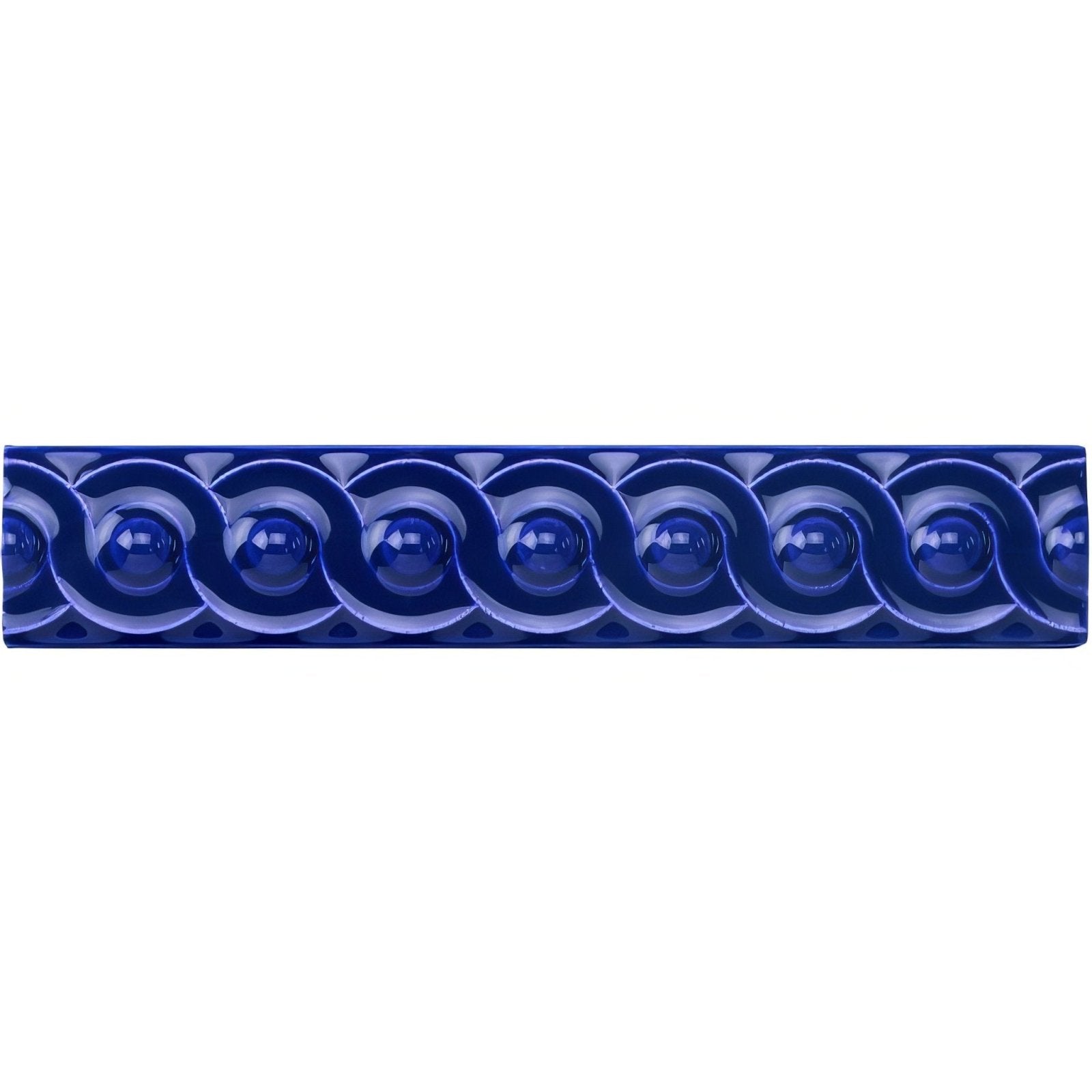 Royal blue scroll moulding ceramic tile in deep cobalt blue with glossy finish and raised wave-like sphere pattern