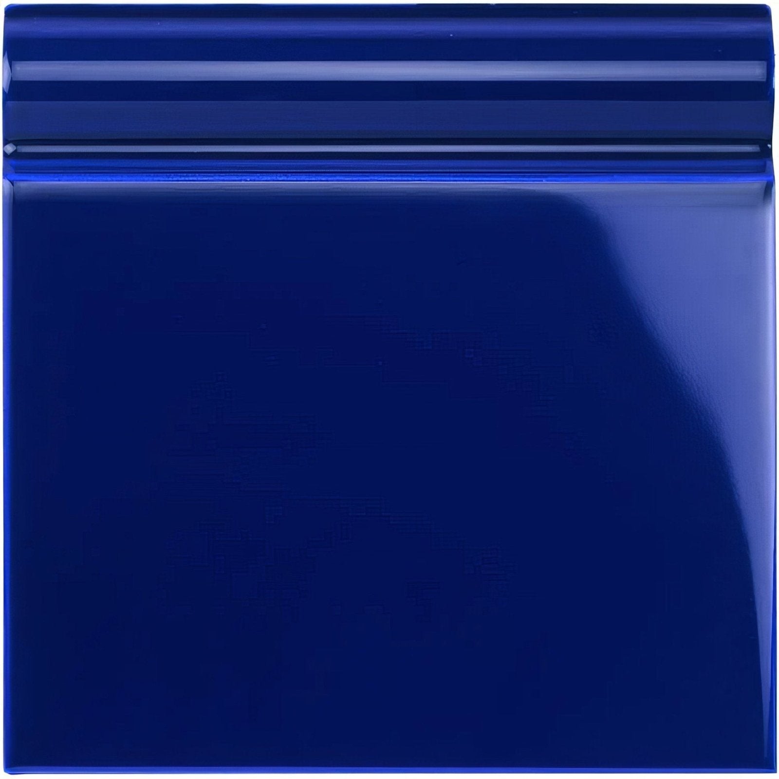 A glossy royal blue ceramic skirting tile with smooth reflective surface and subtle horizontal ridges along the top edge