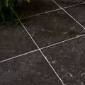 Royal mink limestone tumbled finish dark gray stone tiles with subtle veining separated by white grout lines
