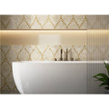Royal Palm Golden Promise white and gold mother-of-pearl mosaic with a freestanding bathtub