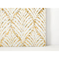 A decorative wall panel royal palm golden promise with an intricate fan-shaped pattern of white and gold mother-of-pearl