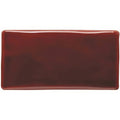 A glossy rectangular ceramic ruby half tile in deep burgundy with rounded edges for wall or backsplash use