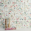 Sakura gardens watercolor floral tiles in soft pinks greens and muted earth tones arranged in a grid pattern