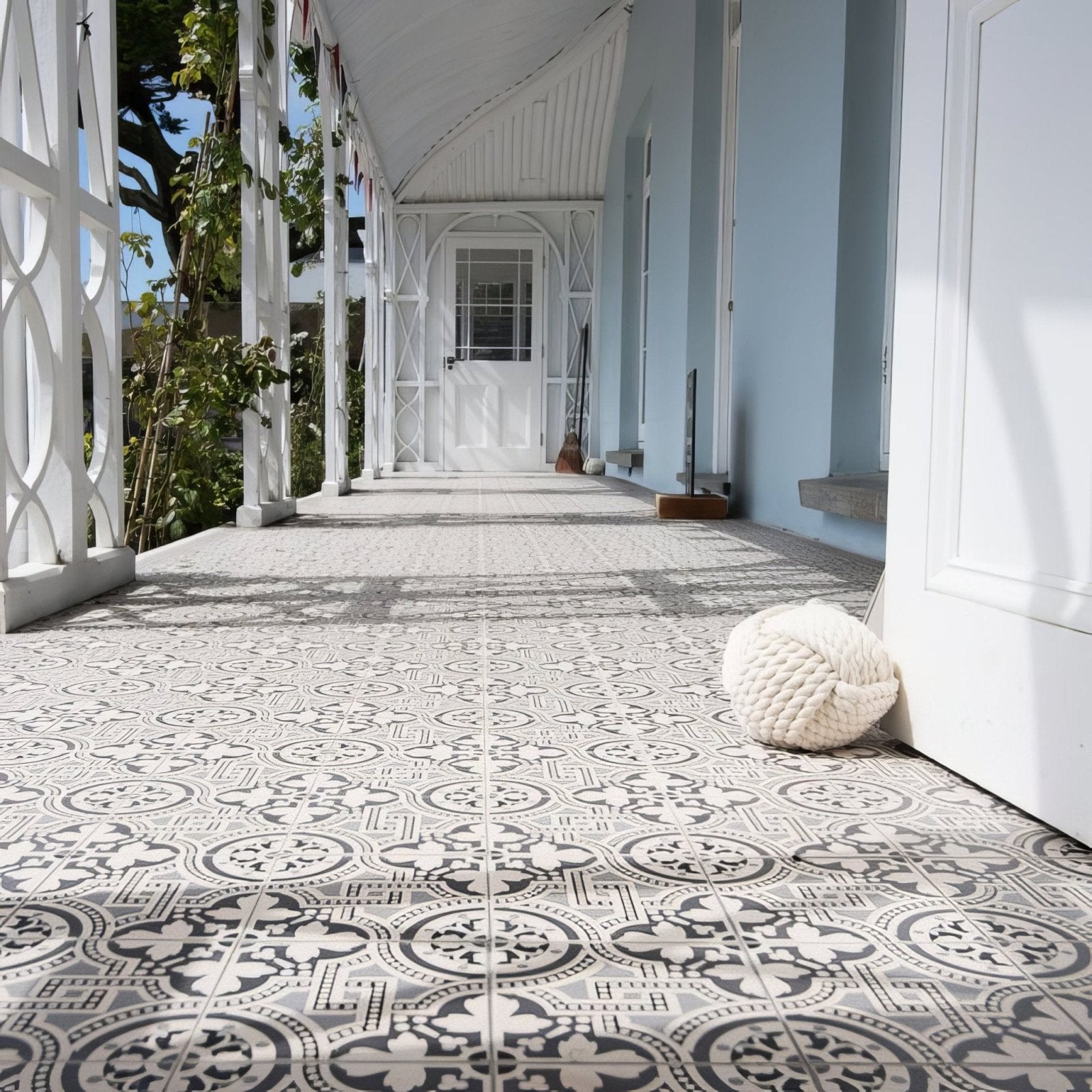 A cream-colored thickly knotted rope ball against a dover white door from the salisbury black collection