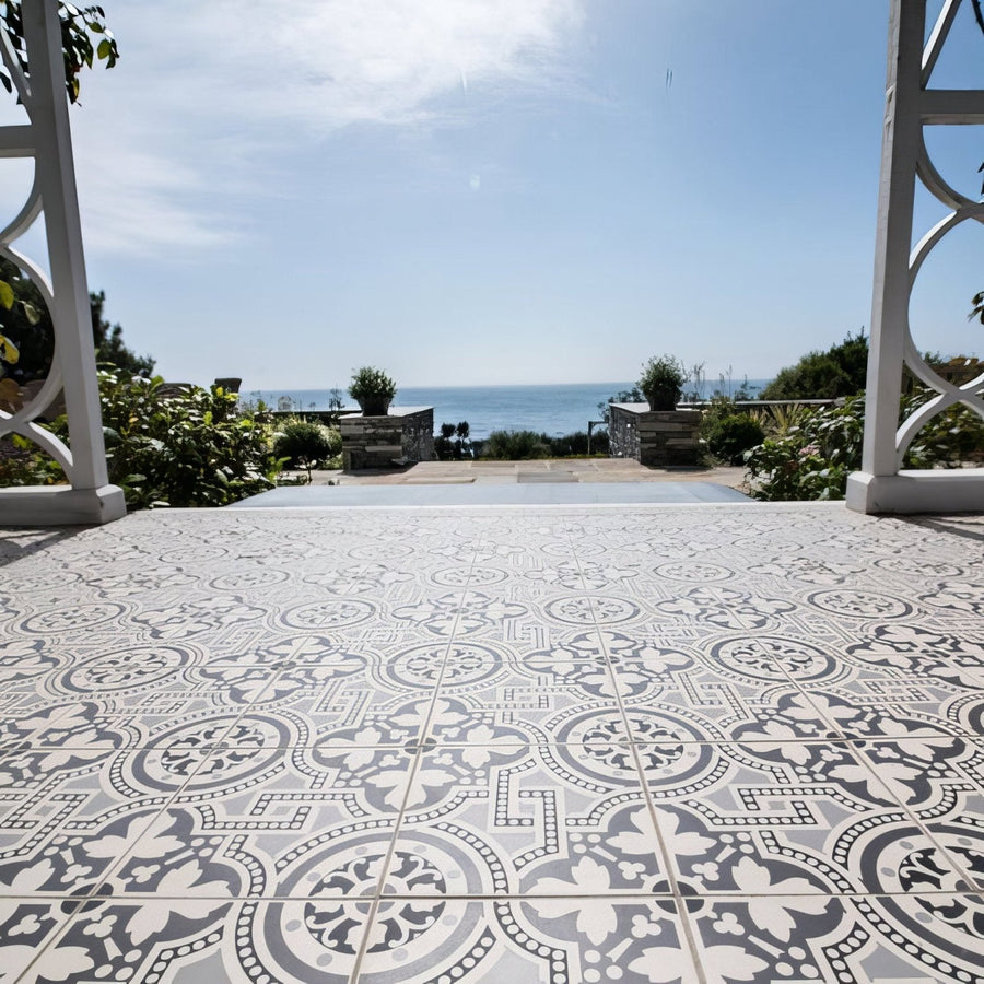 Gray and white patterned ceramic floor tiles with intricate floral and geometric designs in salisbury black on dover white
