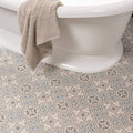 Beige towel draped over the edge of a white bathtub in Salisbury Blue on Dover White bathroom setting