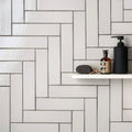 Black pump bottle with matte finish for sand smooth brick tile use displayed from the back side
