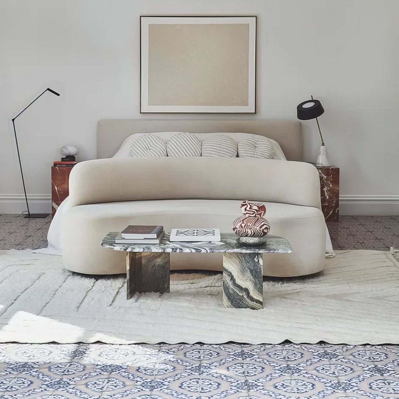 Sardinia Porcelain Masseria blue and terracotta patterned tiles with an upholstered bed