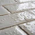 Gray ceramic tiles with crackle glaze surface protected by sarsen home crackle glaze protector and water droplets