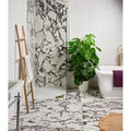 Savoy Porcelain white marble-effect tiles with a potted monstera plant