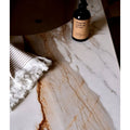 Sculpture Grande Porcelain Calacatta Maximus white marble-effect tiles with a black spray bottle